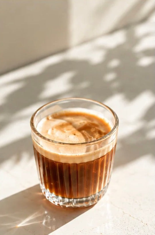 A glass of espresso coffee in sunlight